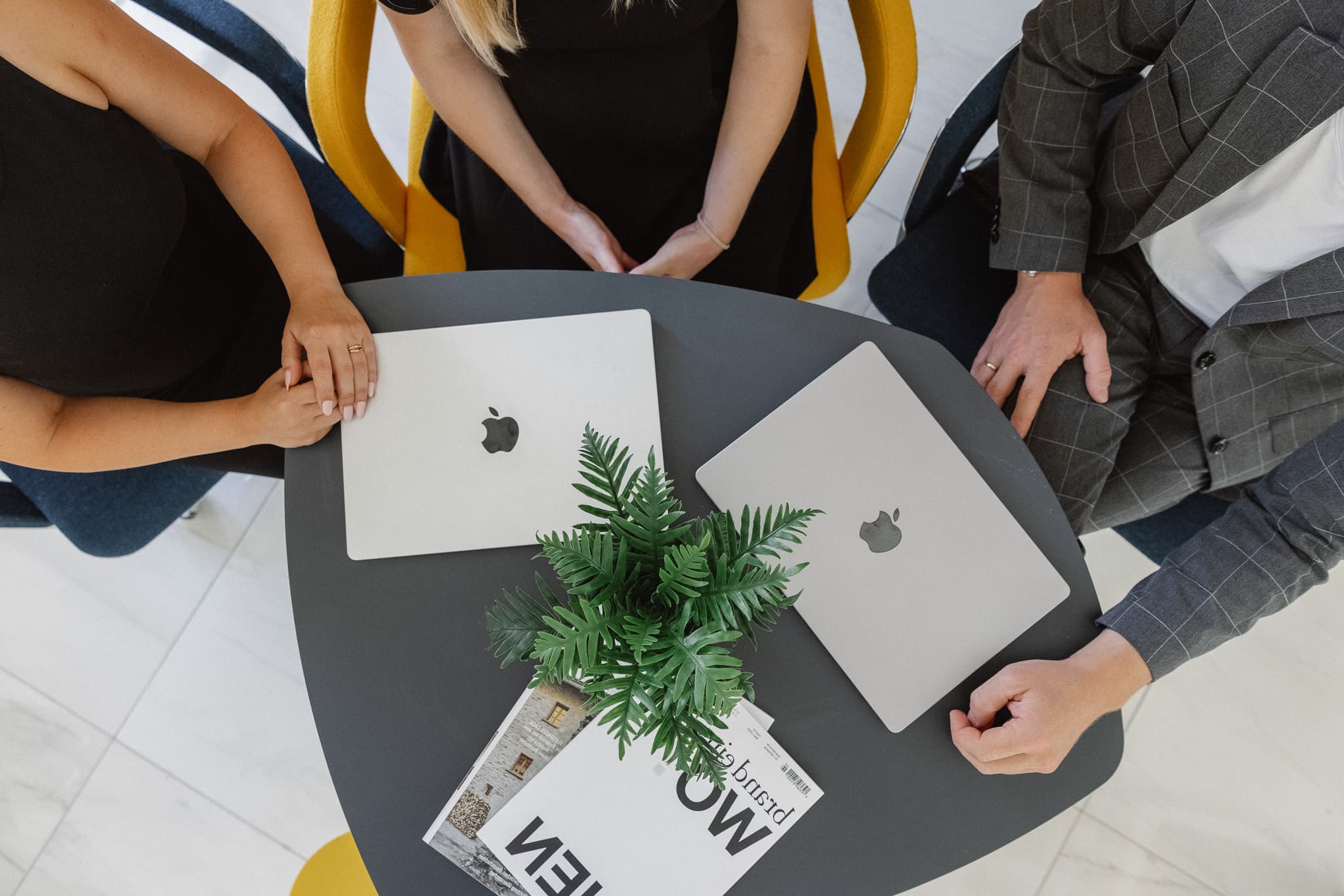 Top-down view of the team table with laptops and work material.